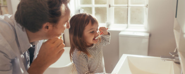 cavity development in father and daughter brushing teeth